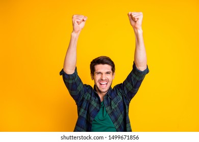 Photo of cool guy watching football game raising fists supporting favorite team wear casual plaid shirt isolated yellow color background - Shutterstock ID 1499671856