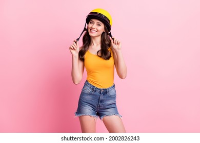 Photo of cool millennial speed lover wavy hairdo lady wear orange top helmet shirts isolated on pink color background - Powered by Shutterstock