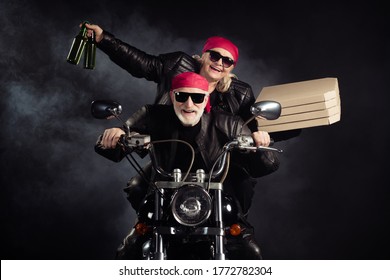 Photo Of Cool Old Bikers White Hair Man Lady Couple Drive Chopper Moto Travel Pensioners Party Bring Takeaway Pizza Beer Bottles Wear Rocker Leather Outfit Isolated Black Color Background