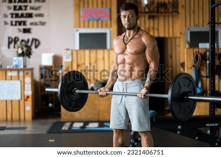 Photo with copy space of a man doing weights with a bar