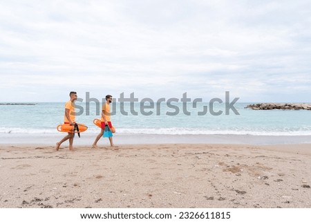 Photo with copy space of two Lifeguards on a empty the beach