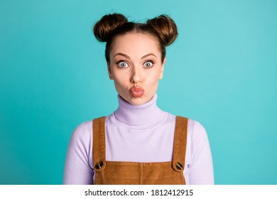 Photo Of Coquettish Crazy Romantic Charming Funny Girlish Silly Two Buns Hairdo Woman Shiny Full Lips Kiss Wear Purple Sweater Brown Corduroy Overall Isolated Shine Turquoise Color Background