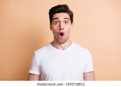 Photo Of Crazy Amazed Young Man Open Mouth Unbelievable Information Isolated On Pastel Beige Color Background