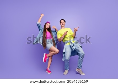 Photo of crazy couple celebrate 90s event guy direct empty space wear pin-up outfit isolated purple color background