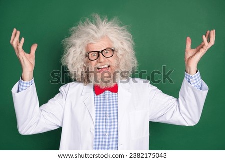 Photo of crazy funky funny scientist physician with messy hair laughing evil experiment isolated on green color background