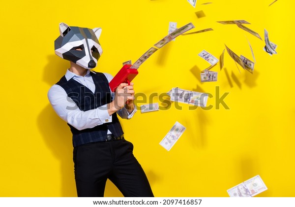 Photo\
of crazy guy racoon mask celebration halloween shoot pistol profit\
money isolated over yellow bright color\
background