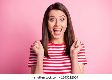 Photo of crazy happy brunette straight hair lady hands fists yelling smiling wear stripy red white cloth isolated over pink color background