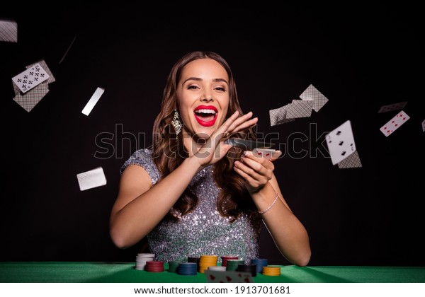Photo of crazy lady\
sit poker table throw cards open mouth wear glossy dress isolated\
black color background