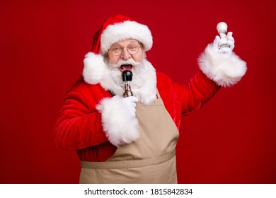 Photo of crazy modern stylish santa claus sing song x-mas salt pepper wear red costume apron cap headwear isolated over bright shine color background