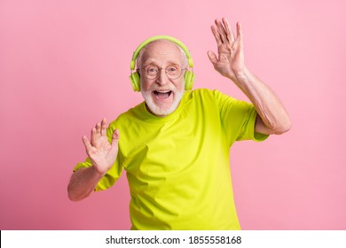 Photo Of Crazy Optimistic Old Man Listen Music Dance Arms Wear Headphones Spectacles Lime Color Clothes Isolated On Pink Background