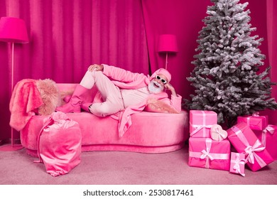 Photo of crazy pensioner bearded male santa claus lying sofa fancy boots fur coat fluffy nighty hat cool pink christmas decoration x-mas - Powered by Shutterstock