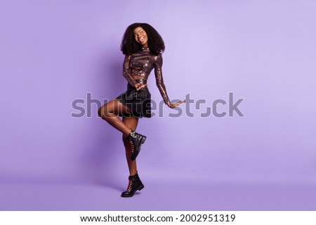 Photo of crazy young lady dance look empty space wear glossy shirt mini skirt footwear isolated violet color background