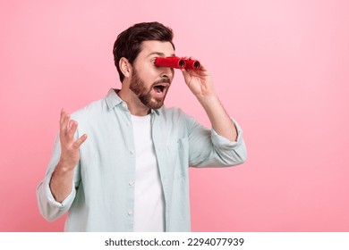 Photo of crazy young man hold vintage binocular glasses looking empty space theater opera performance isolated on pink color background - Powered by Shutterstock