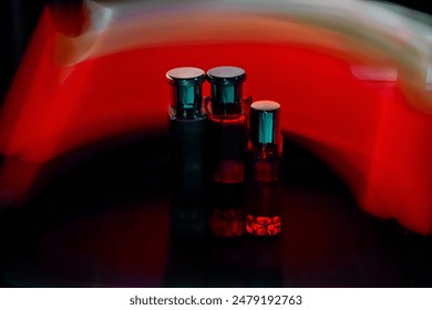 Photo creation using a slow shutter speed, with 3 perfume bottles as the object, or light painting