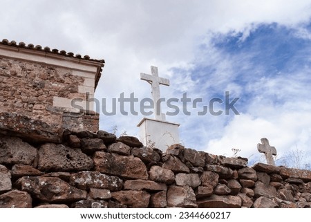 Photo of a cross in a stone church cemetery