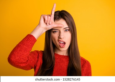 Photo Of Cruel Rude Bad School Youngser Showing You Lose Sign Grimacing Arrogant Facial Expression Isolated Over Yellow Vibrant Color Background