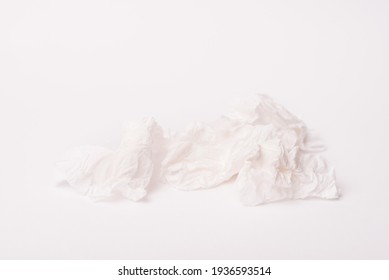 Photo Of A Crumpled White Used Paper Napkin Over White Background