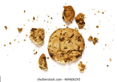 A Photo Of A Crunchy Chocolate Chips Cookie With Crumbs Around It, Shot From Above On A White Background, With Copyspace