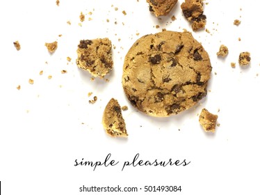 A Photo Of A Crunchy Chocolate Chips Cookie With Crumbs Around It, Shot From Above On A White Background, With Copyspace