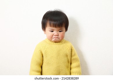 Photo of a crying Asian girl.