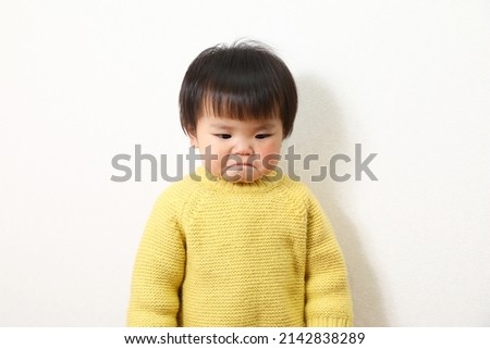 Photo of a crying Asian girl.