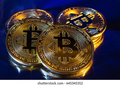 Photo of cryptocurrency physical golden bitcoin coin on colorful background
