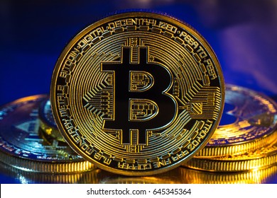 Photo of cryptocurrency physical golden bitcoin coin on colorful background