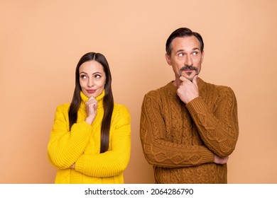 Photo Of Curious Brunette Couple Hand Face Look Empty Space Wear Autumn Knitwear Sweater Isolated On Beige Color Background