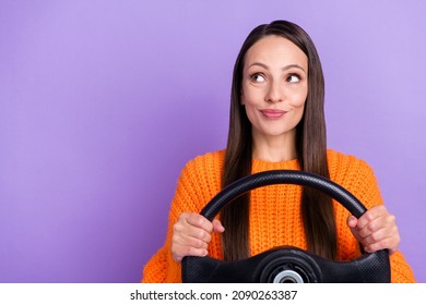 Photo Of Curious Dreamy Lady Hold Steering Wheel Look Empty Space Wear Orange Sweater Isolated Purple Color Background