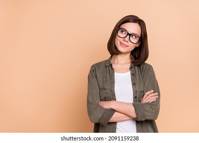 Photo of curious lady folded hands look empty space wear eyeglasses khaki shirt isolated beige color background - Powered by Shutterstock