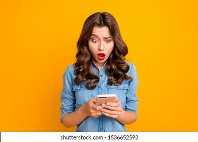 Photo of curly wavy cute brunette nice charming casual girl having seen disappointing message on her phone with terrified facial expression isolated over vivid color background