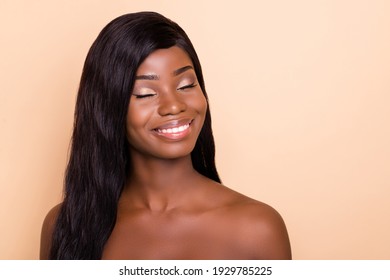 Photo of cute adorable dark skin nude woman smiling closed eyes isolated beige color background