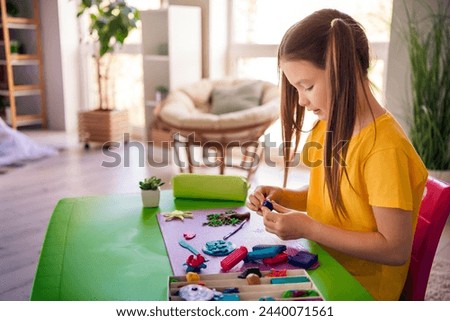 Photo of cute adorable girl daughter sitting desk doing homework handicraft lesson course education from home indoors