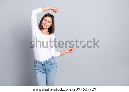 Photo of cute brunette millennial lady index empty space wear outfit isolated on grey color background