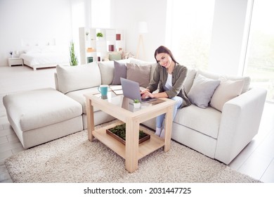 Photo Of Cute Busy Young Woman Dressed Green Shirt Sitting Couch Talking Workig Modern Gadgets Indoors House Home Room