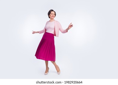 Photo of cute charming age woman dressed pink outfit dancing smiling isolated white color background