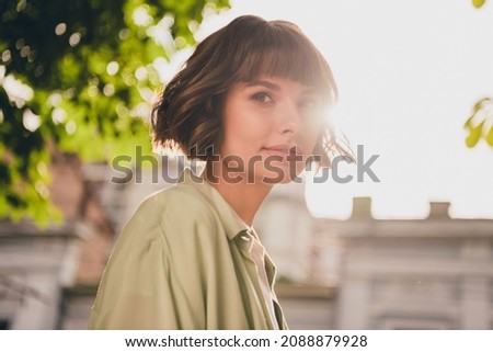 Photo of cute charming young woman wear green shirt rucksack smiling walking outside city street