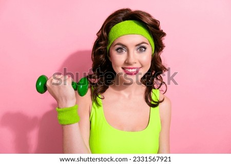 Photo of cute cheerful sportive lady toothy smile arm hold lifting dumbbell effort determination isolated on pink color background