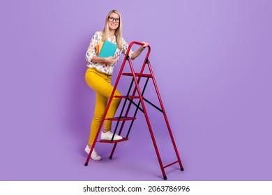 Photo of cute clever mature lady dressed print blouse glasses holding copybooks rising stairs smiling isolated purple color background - Powered by Shutterstock