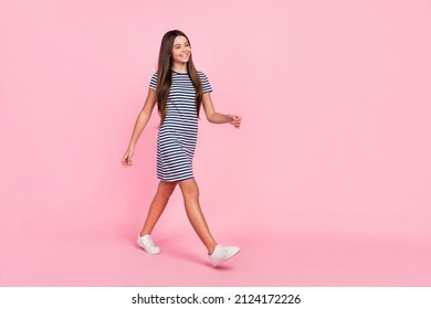 Photo Of Cute Dreamy Girl Dressed Striped Dress Walking Looking Empty Space Isolated Pink Color Background