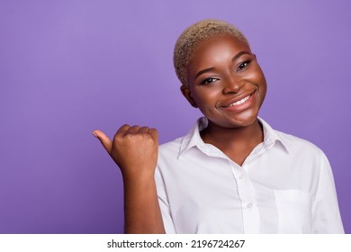 Photo Of Cute Dreamy Short Hair Lady Wear Smart Casual Look Pointing Thumb Empty Space Isolated Purple Color Background