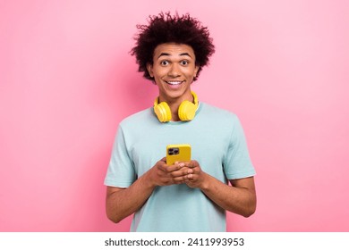 Photo of cute funky man dressed blue t-shirt headphones chatting modern device isolated pink color background - Powered by Shutterstock