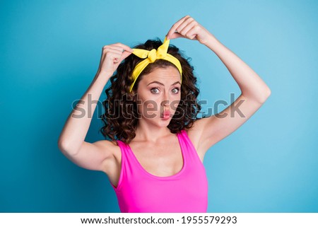 Photo of cute funky young woman fix yellow headband send air kiss summer isolated on pastel blue color background