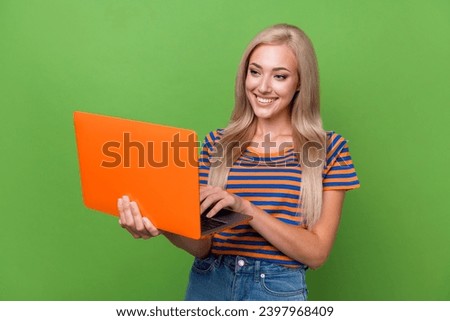 Photo of cute lovely girl wear striped trendy clothes write email letter modern macbook device gadget isolated on green color background