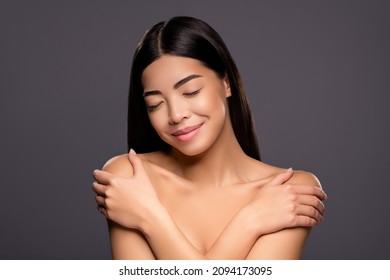 Photo Of Cute Lovely Positive Chinese Lady Hands Hug Shoulders Close Eyes Enjoy Soft Skin Isolated Grey Color Background