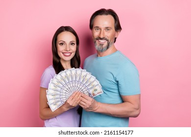 Photo Of Cute Married Mature Couple Win Lottery Receive Dollars Money Become Rich Isolated On Pink Color Background