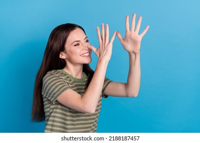 Photo of cute millennial brunette lady play look promo wear striped t-shirt isolated on blue color background - Shutterstock ID 2188187457