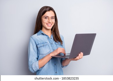 Photo Of Cute Pretty Woman Stand Typing Laptop Wear Spectacles Blue Shirt Isolated On Grey Color Background