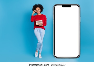 Photo Of Cute Smart Woman Wear Knitted Sweater Holding Book Stack Modern Device Empty Space Isolated Blue Color Background