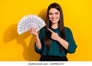 Photo Of Cute Sweet Lady Dressed Green Shirt Pointing Finger Cash Fan Isolated Yellow Color Background